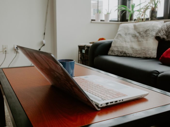 computer sitting on coffee table in apartment